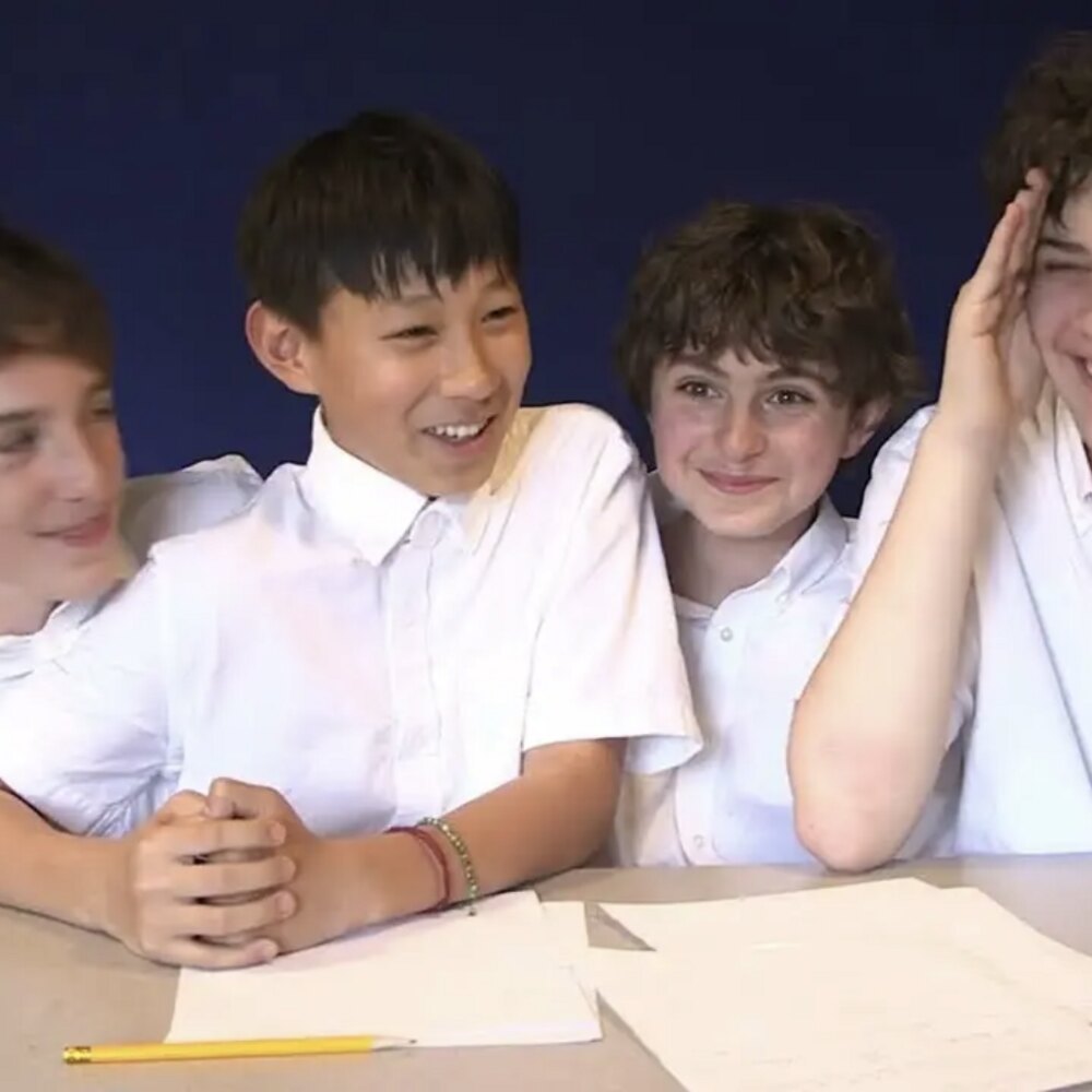 The cast of School Paper around a table